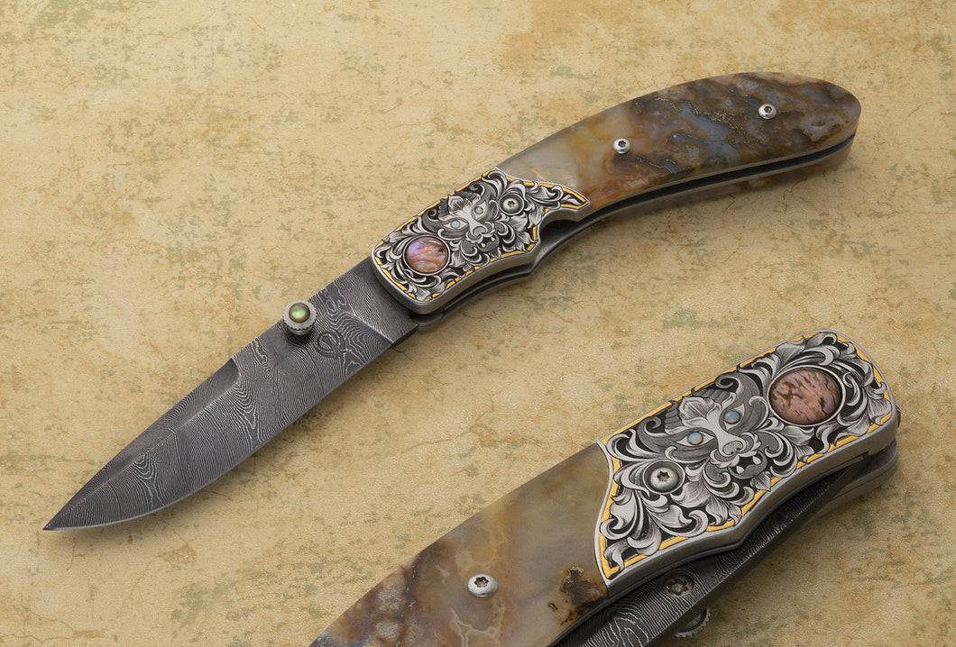 Engraved plume agate folding knife