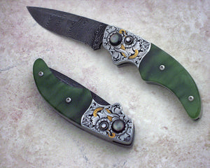 Engraved jade button lock folding knife