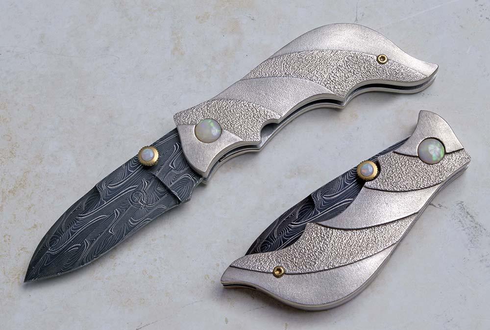 Carved silver folding knife