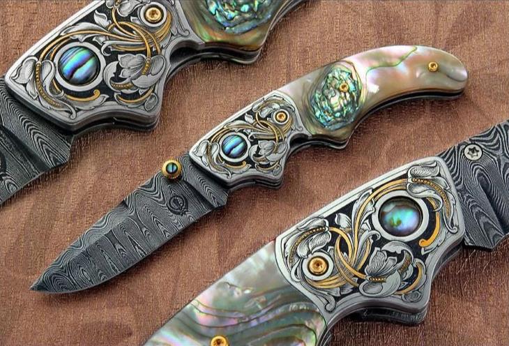 Engraved abalone handled folding knife