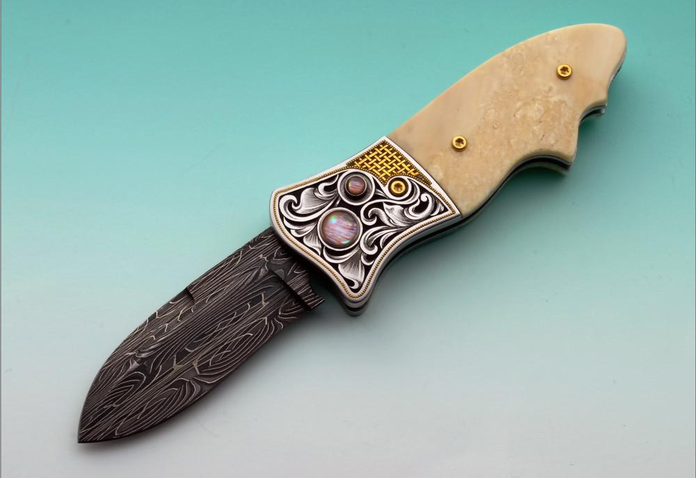 Engraved ivory button lock folding knife